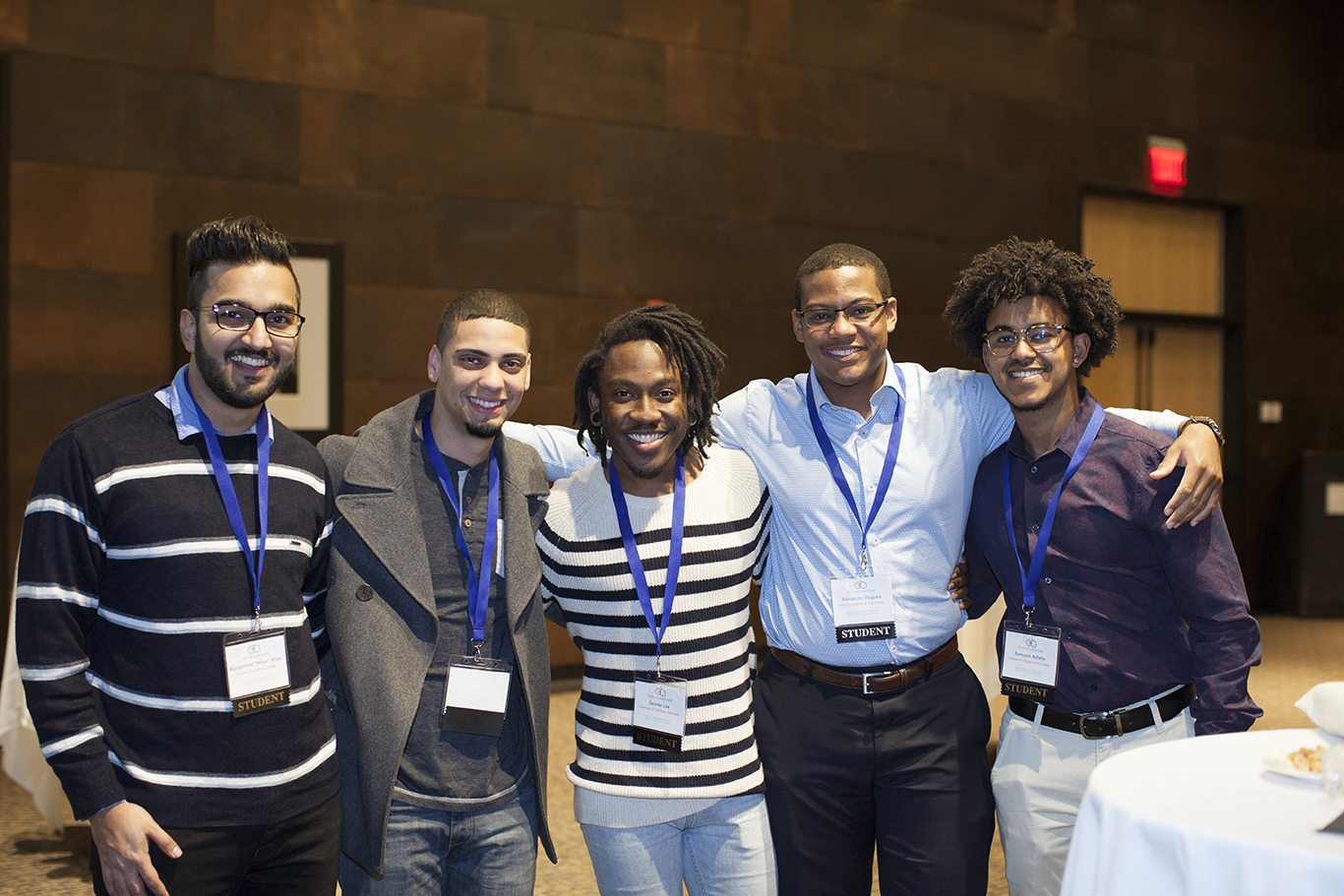 Group of students smiling at a conference.